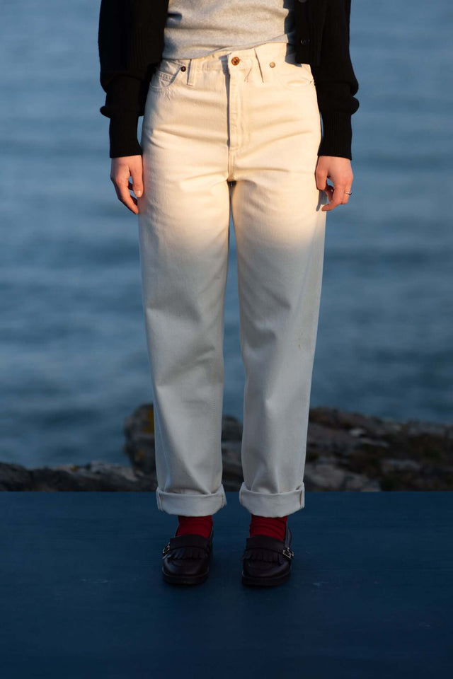 Person wearing light-colored pants with a blurred background
