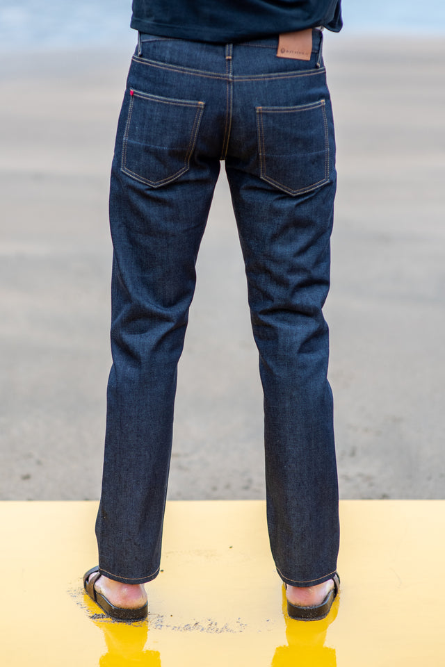 Person wearing blue jeans with a blurred background