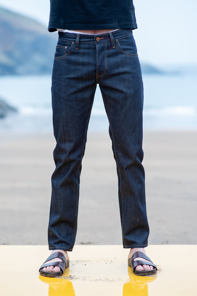 Person wearing blue jeans with a blurred background